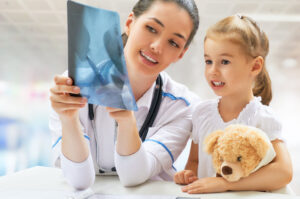 doctor showing a small child an xray