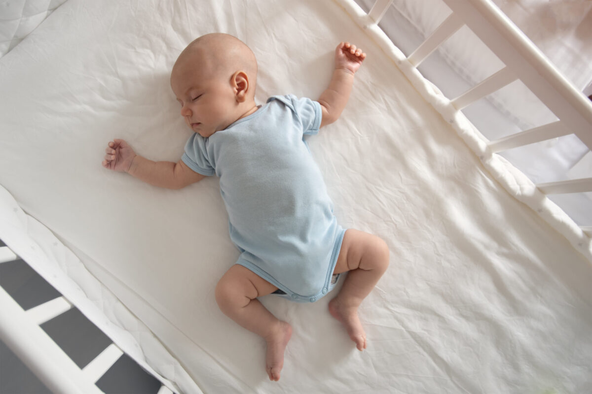 Peaceful sleeping baby in a crib.